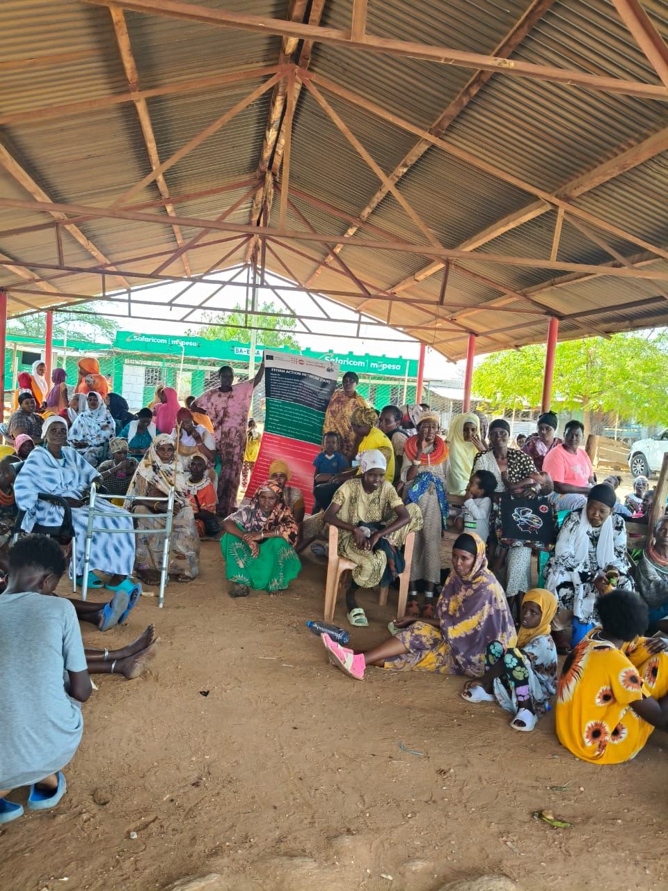 Elderly women at a FAN community meeting under a tin roof shelter in Laisamis
